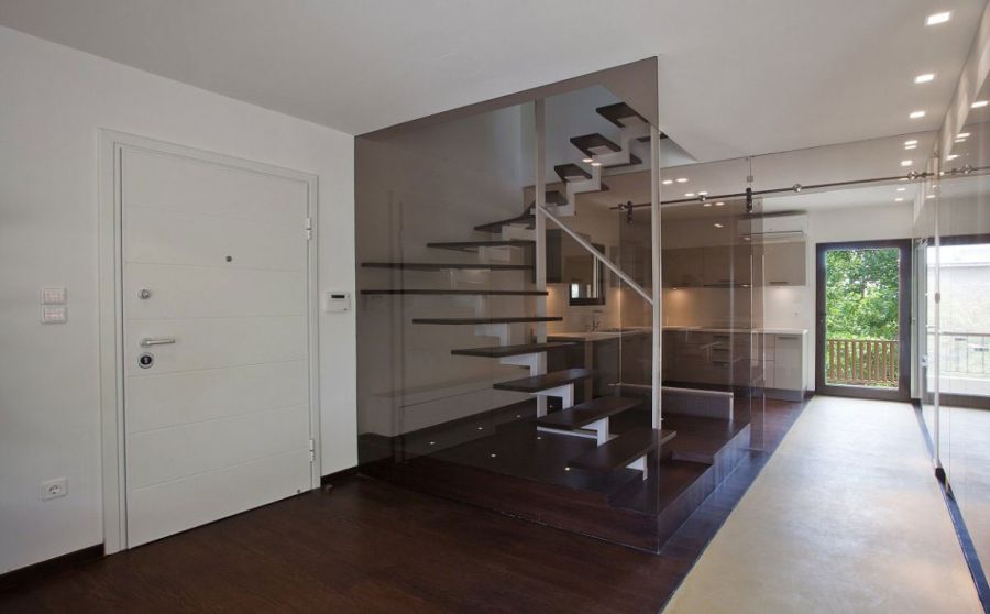 View of the kitchen behind the staircase