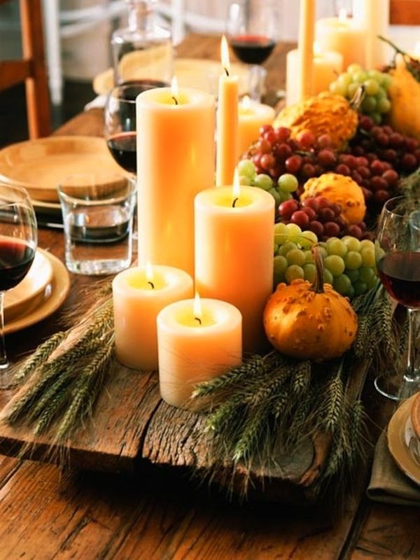 Candles coupled with fall produce on the Thanksgiving table