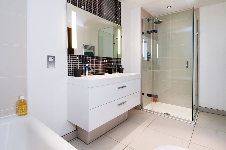 Contemporary bathroom in white and glass shower area