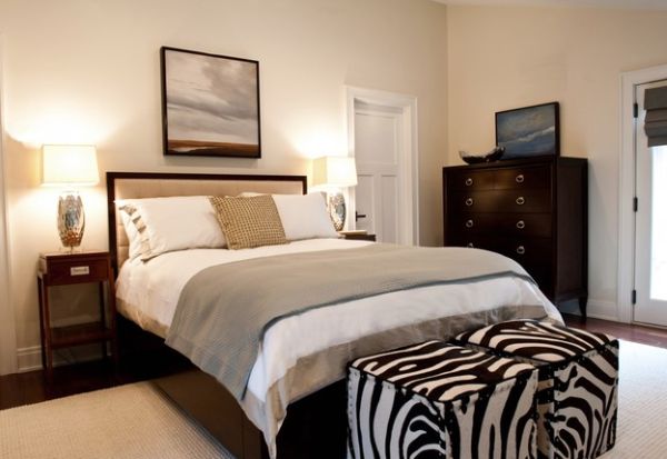 Cube ottomans in zebra print at the foot of the bed give the bedroom a glam makeover