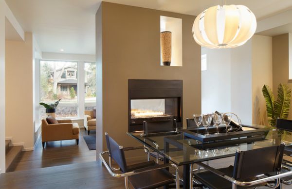 Elegant fireplace warms up both the kitchen and the dining area