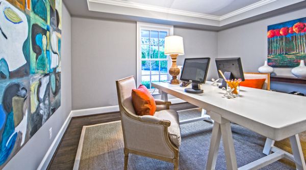 Elegant home office with colorful art work on the walls