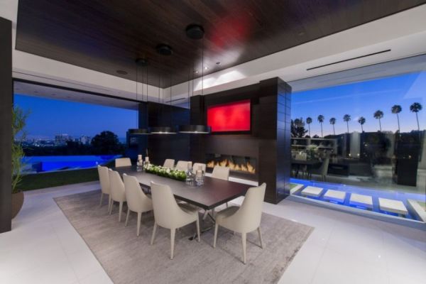 Lavish contemporary dining area with fireplace