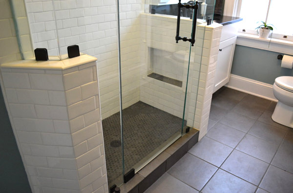 Matching tile floor and shower floor in a small bathroom