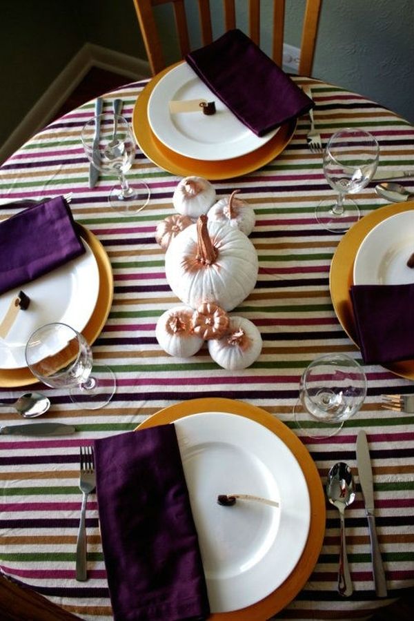 Multicolor striped tablecloth gives the Thanksgiving table a trendy look