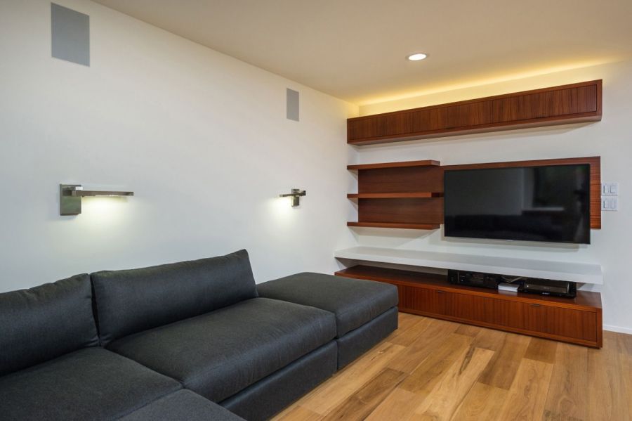 Sleek floating shelves in the living roomw with a grey sofa