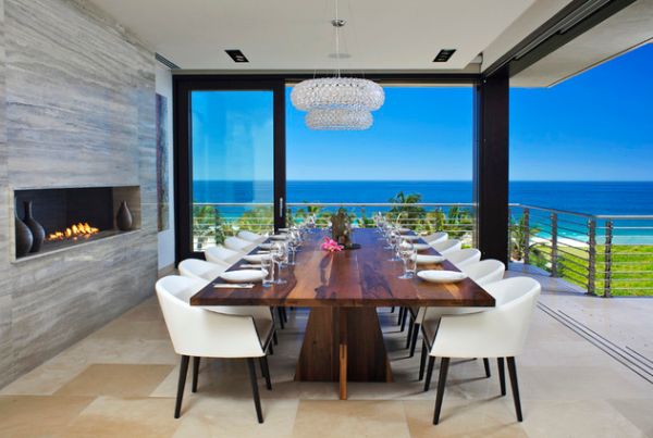 Stunning dining room with ocean views and a contemporary stone fireplace