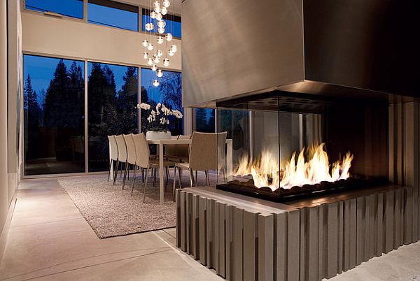 Stylish fireplace serves both the dining room and the kitchen