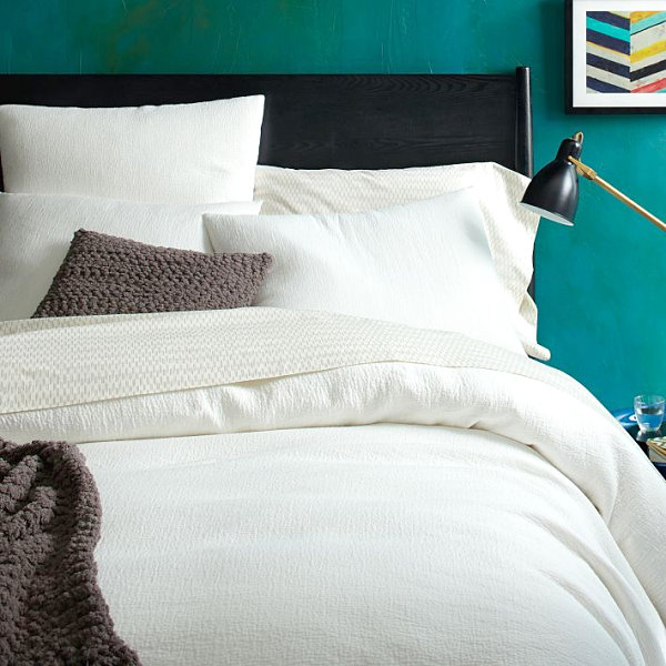 Teal bedroom with white duvet