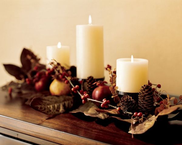 Thanksgiving table centerpiece with pine cones and pomegranates