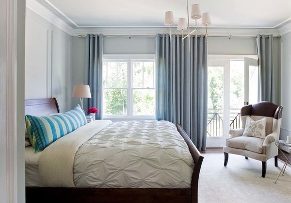 The sleigh bed anchors the bedroom filled with cool blue shades