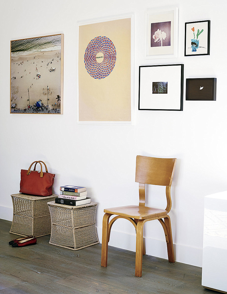 Wall of artwork in an eclectic hallway