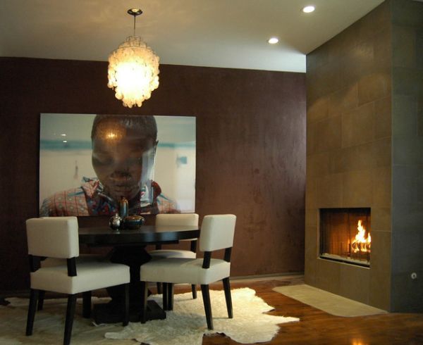 White cow hide rugs in the dining room give it a snug look