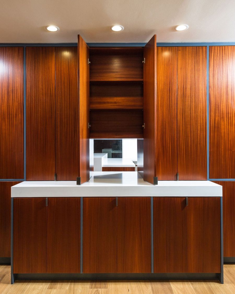 Wooden cabinets open up to reveal a window