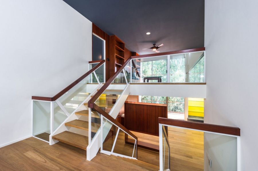 Wooden staircase with glass railing