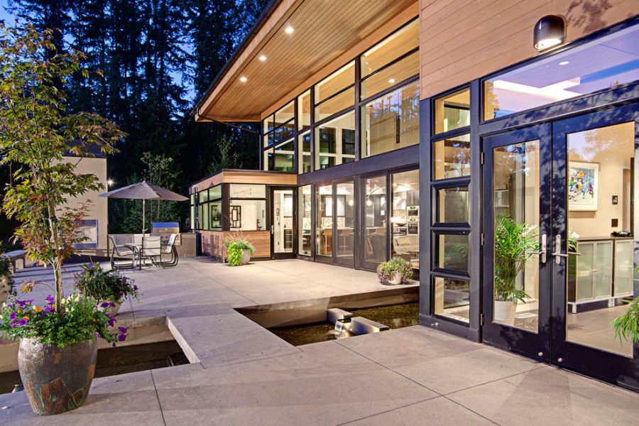 large glass windows connect the indoors with the landscape