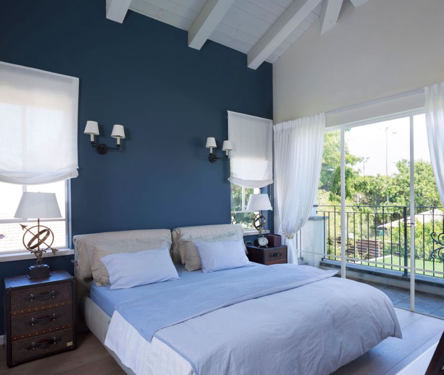 master bedroom of Tel Aviv home in white and blue