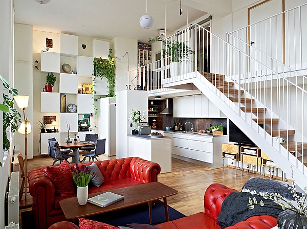Green walls and colorful decor accentuate the look of this Swedish loft