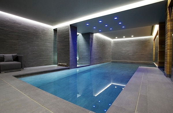 Grey walls and recessed lighting give this indoor pool a minimalist appeal