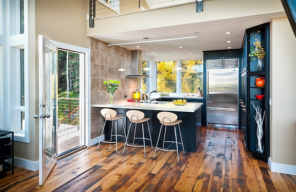 Light shade of the bar stools offers lovely contrast to the dark kitchen backdrop