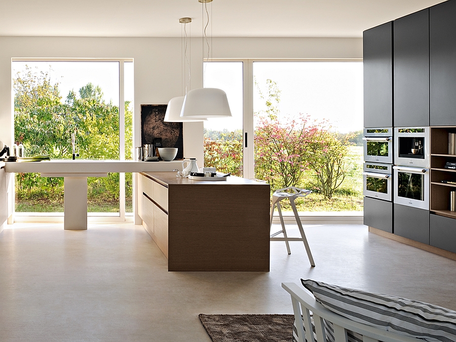 Open glass doors bring in the view outside the modern kitchen