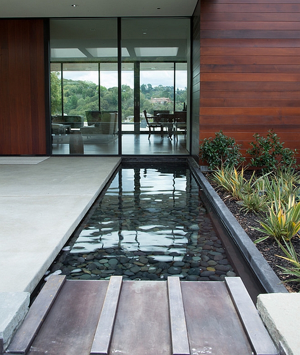 SImple and stylish water feature mirrors the contemporary glass facade beautifully