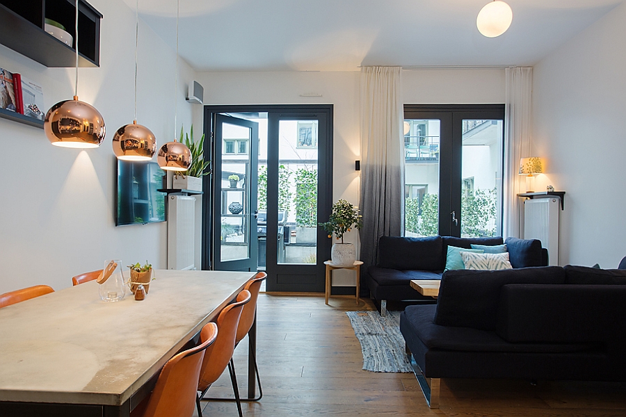 Striking copper pendant lights above the dining table