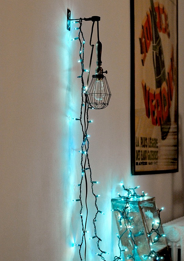 String lights elegantly draped over a mounted cage light in the home office