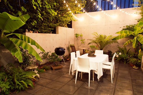 String lights over a verdant patio