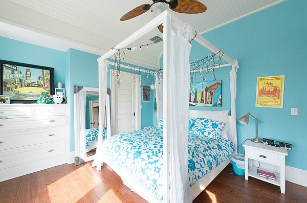 Trendy modern bedroom with string lights and a canopy bed