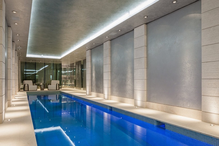 lavish indoor swimming pool with recessed lighting