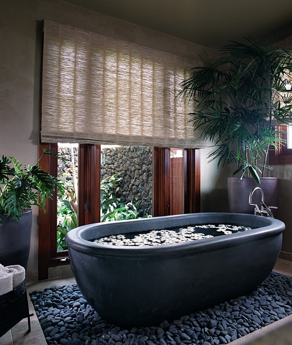 Beautiful basalt tub placed in a bed or river rocks