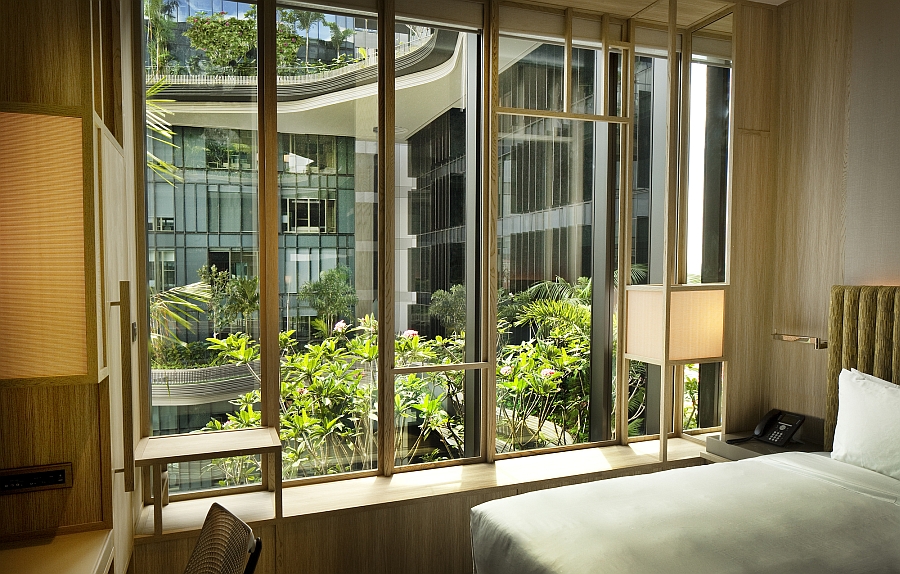 Bedroom at the PARKROYAL on Pickering with a view of green balconies