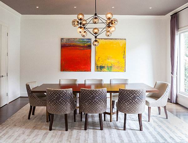 Dining room with yellow and red artwork