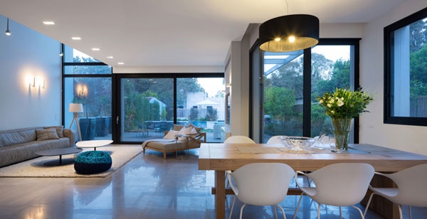 Large black drum pendants and wooden dining table