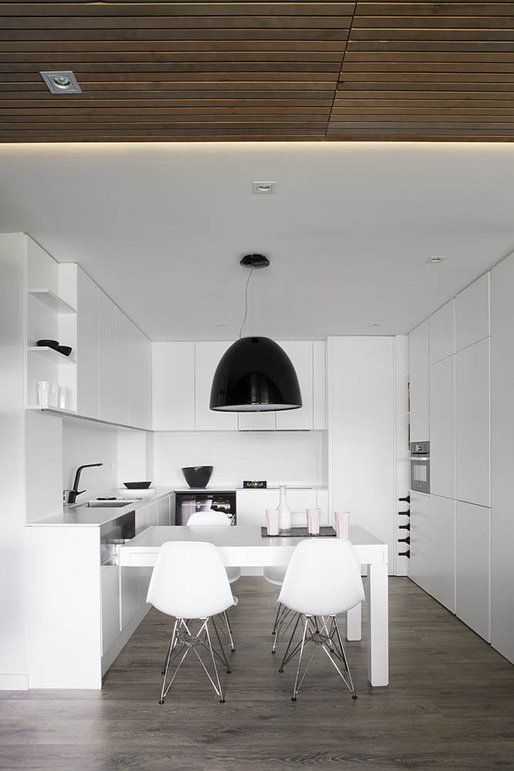 Large black pendant light above the dining area