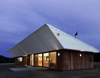 Energy-Efficient Home Charms With A Distinct Roof And An Earthy Ambience