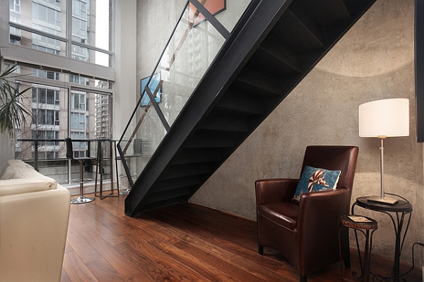 Metal staircase with glass railing in a contemporary loft