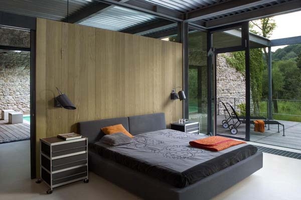 Minimalist bedroom in grey with glass walls