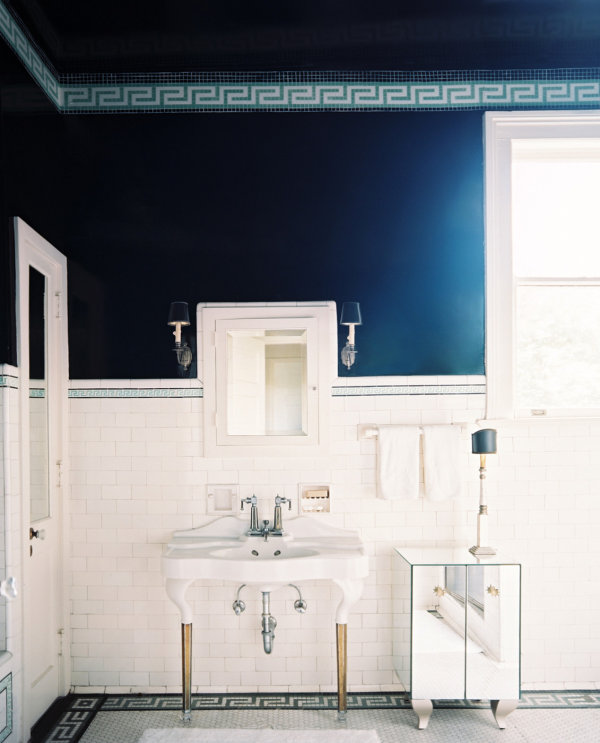 Mirrored cabinet in a navy and white bathroom