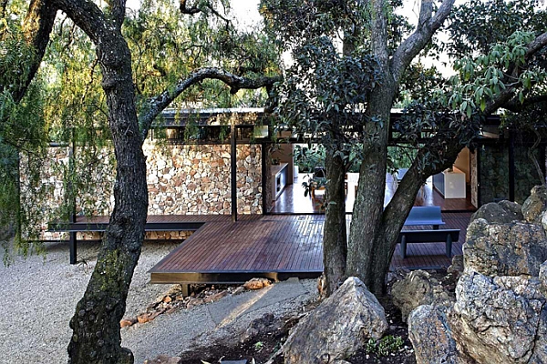 Natural canopy offers shade to the steel-framed home