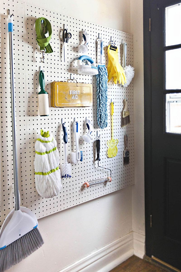 Pegboard wall of cleaning supplies