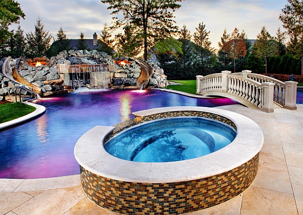 Twin slides on either side of the waterfall add a playful element to the pool design