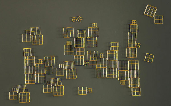 Wall sculpture made from brass cubes