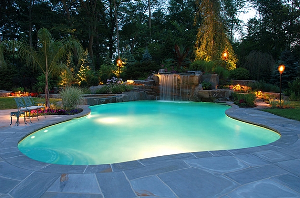 Waterfalls cascade over natural stone and into the gorgeous pool