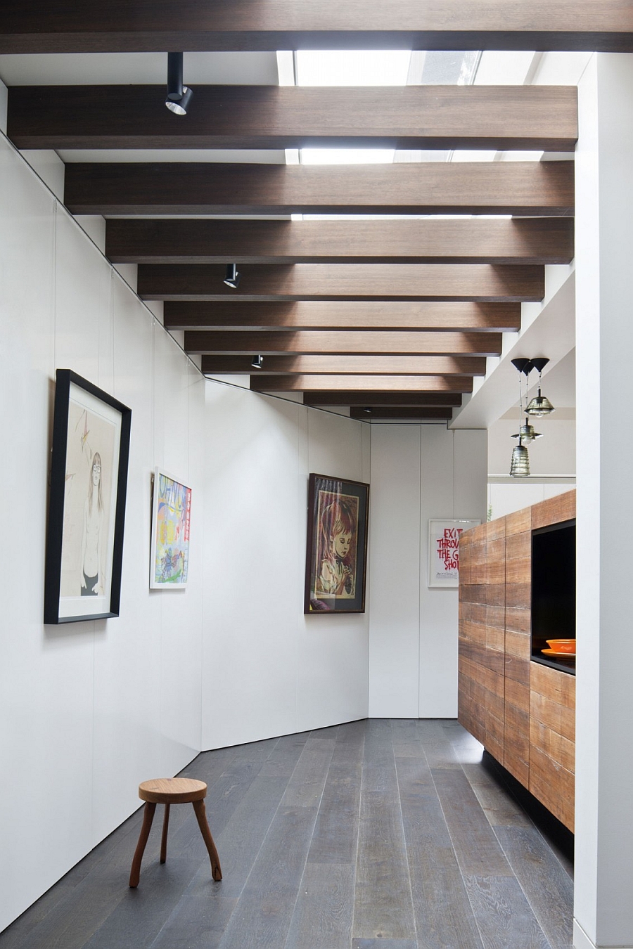 Wooden beams on the ceiling and an art gallery like setting