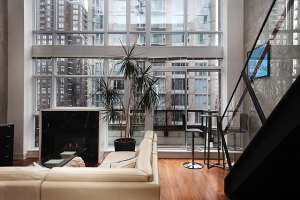 large glass windows and a fireplace in the living room