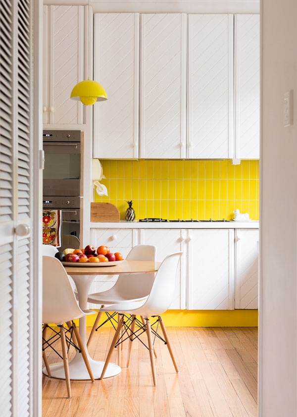 Bright yellow details in a crisp kitchen