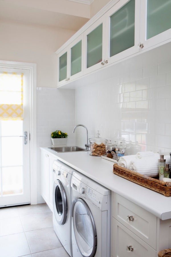 White laundry room with upper cabinets