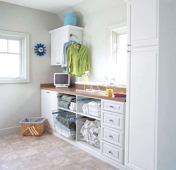 Open shelving with pullout drawers in a crisp laundry room